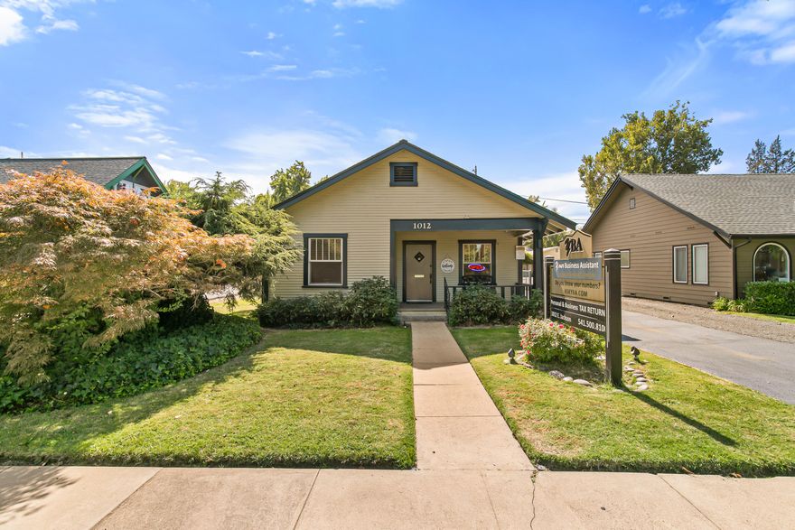 Well-maintained 1,774 sqft. commercial office building offers excellent street appeal & prime visibility on E. Jackson St, a high-traffic area in E. Medford. Fantastic layout w/welcoming reception area, file rm & 5 private offices (2 w/sinks).  Separate area upstairs w/breakroom & lg office. 2 bathrooms, one ADA assessable. Property is both functional & accommodating. Building previously configured as commercial duplex w/separate back entrance & locking door is still in place. Updated tech infrastructure. Parking includes 4 designated spaces in rear, extra parking on side & unlimited parking on other side of E. Jackson & Mae St too. Recent Updates: Lg remodel in 2008. Refinished wood floors, new roof, can lighting & interior paint in 2018. New exterior paint & new HVAC 2024. Sewer line replaced 2023. Asphalt sealed 2025. This clean, professional space is a rare opportunity in a sought-after location—perfect for medical, legal, counseling or general office use. Schedule your tour today