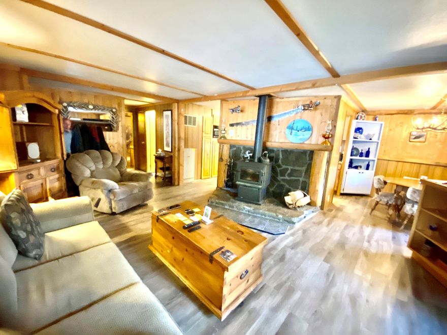 55+ community only 15 minutes from Redmond airport. This updated rustic home is move in ready. High fence yard with raised garden beds to enjoy the wildlife while keeping your garden safe. New roof, floor, woodstove, and windows. Seller is taking his clothes and home is being sold with all appliances, furnishings, new window AC 4 post lodgepole bed, all kitchen supplies and everything on the walls. Also 65 inch TV with surround sound, radio and the entire cabin like decor.  Your chance to just take your clothes and start all over. Seller moving out of state. Carport for boat, car or other toys plus 3 extra storage sheds. Front and back covered porch. Seller even leaving firewood, rocking chair and all outside garden art. This is a great opportunity for next phase of your life with a fresh new start. Manufacture home only. NO LAND. Owner occupy only. NO SUBLEASE.$680.00 monthly space rent includes water garbage, sewer and snow removal.