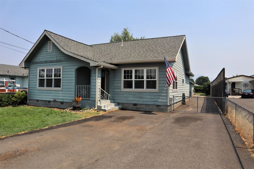 This Adorable Home is located in a quiet, established neighborhood close to shopping and services. It features Concrete-Based Siding, Concrete Block perimeter foundation, Hardwood Floors, Newer energy efficient Vinyl Double-Paned Windows throughout, Newer Roof. High efficiency dual fuel HVAC system, Big Privacy-fenced yard with Patio, In-ground Sprinkler system, Gated RV parking and a 400 sq ft detached Shop/Studio building, with power, which could be returned to a garage if wanted. This Charming home has a Formal Dining Room, with original built-ins and leaded glass window. Existing range is being replaced with a Brand New Gas Range/Oven. New Interior Paint. One look at this beautiful little Home and you will fall in love!