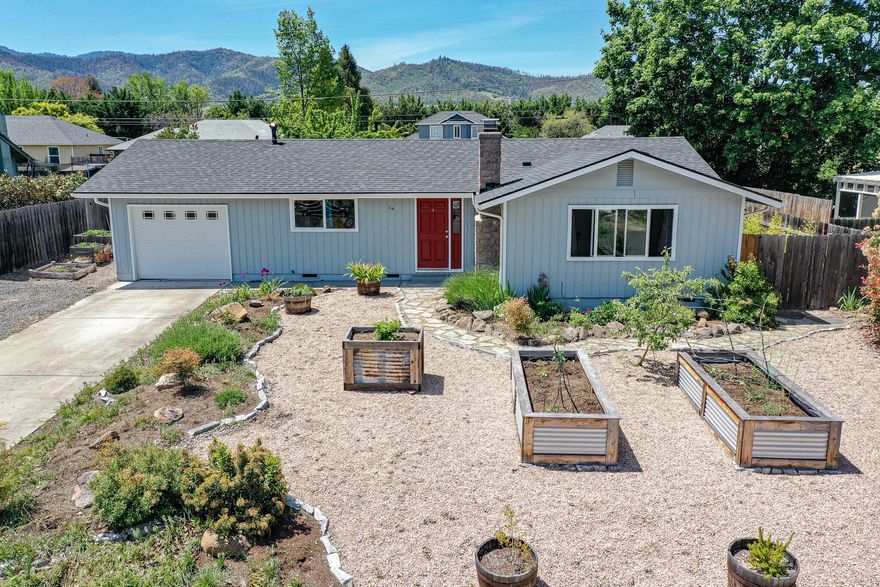 Affordable Talent home in great location on a cul de sac. The home features hardwood floors throughout, newer roof, new HVAC system with gas heat and central air.. Nice fireplace. Raised beds and easy care landscaping. Flagstone patio. Nice fenced yard. Secondary access gate to the large rear yard. Walking distance to elementary and middle school and shopping and post office. Attached , finished garage. Some fruit trees. Nice home, nice location and nice price.