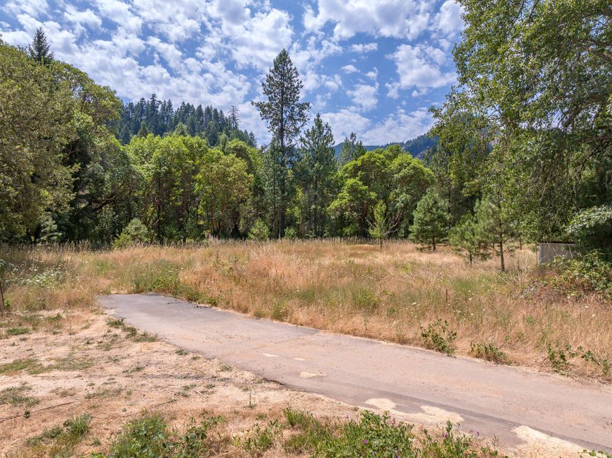 Rural Business Opportunity!  2.2 acres of rural commercial land in Wolf Creek with convenient access to the I-5 for easy travel from Canyonville to the North and Grants Pass from the South. The lot is open and usable while retaining some trees for buffers from the interstate, there is a septic system, public power, and domestic water on the property.  The lot borders Wolf Creek which provides irrigation and stock water rights to the property.  The lot provides an opportunity for a variety of uses from travel accommodations or a repair shop to a fitness center.  The zoning also allows for a single family residence in conjunction with a business.