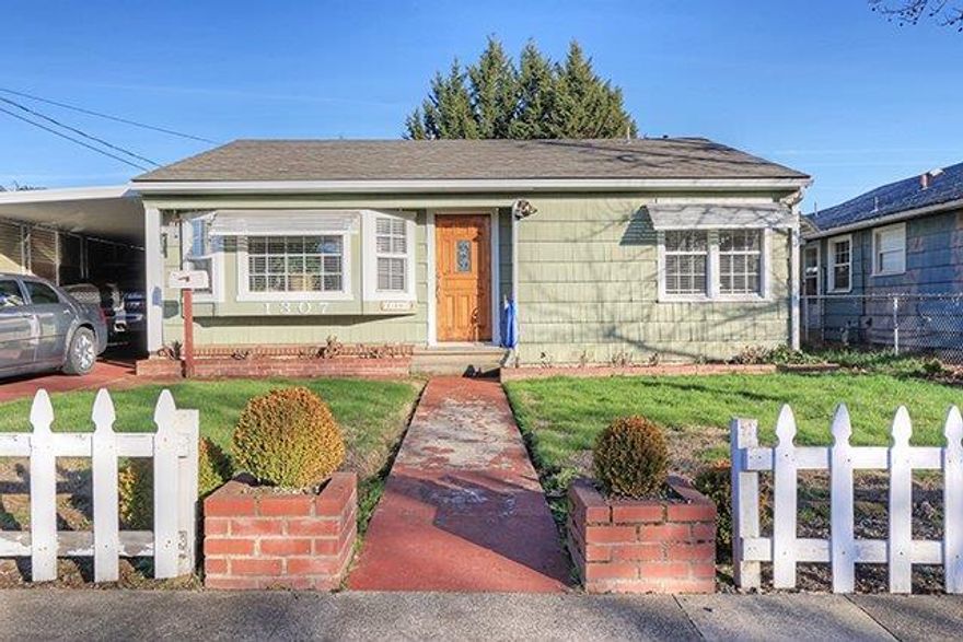 You'll love this charming cottage that sits just one block from historic Washington Blvd. This 3 bedroom, 1 bathroom home will give you 1,497 sq. ft. of generous space to move about. A large living room that flows into the dining room allows for entertaining throughout the year. Hardwood floors under the carpet in the main living area and 2 bedrooms would need very little work to bring them back to their former glory (per Seller). New roof in 2016 as well as many other upgrades. Enjoy gatherings outside on the generously-sized outdoor patio. Situated in a welcoming community that's close to down town Grants Pass.