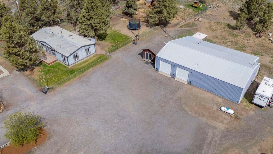 Nestled at the foot of the stunning Cascades, and just minutes from Bend, enjoy breathtaking views and the peace of country living, 
The expansive 36x64 heated shop offers endless possibilities—ideal for a workshop or hobby space. Plus, there's great potential to convert part of the shop into a guest apartment or ADU (buyers to handle permitting and finishing touches).
Other structures include a 24x24 barn, chicken coop, and animal shelter, along with a 1,377 sq ft, 3-bed, 2-bath home. The home features large front and back decks perfect for soaking in the views. 
Plans for a 3,000 sq ft home with detached garage are already in place, giving you room to grow. This property is perfect for outdoor enthusiasts. Future development potential as Bend grows, don't miss the chance to own this incredible property!