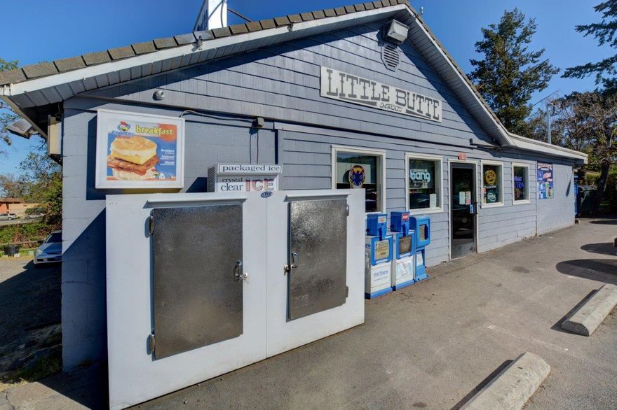 The Little Butte Mini Mart Convenience Store has been a Downtown Eagle Point landmark for decades. Located on the beautiful Little Butte Creek, right next to the Old Covered Bridge, it is one of the few prime real estate locations left. And this is the ONLY convenience and grocery store in all of the Eagle Point downtown area. The convenience store business is included in the sale, along with the land, building and the attached two bedroom apartment. Gross sales were $1.6M in 2020 and $1.9M in 2021. Financial documents on file and available with your signed non-disclosure agreement with a qualified buyer. Buyer to do your own due diligence on all aspects of the sale.