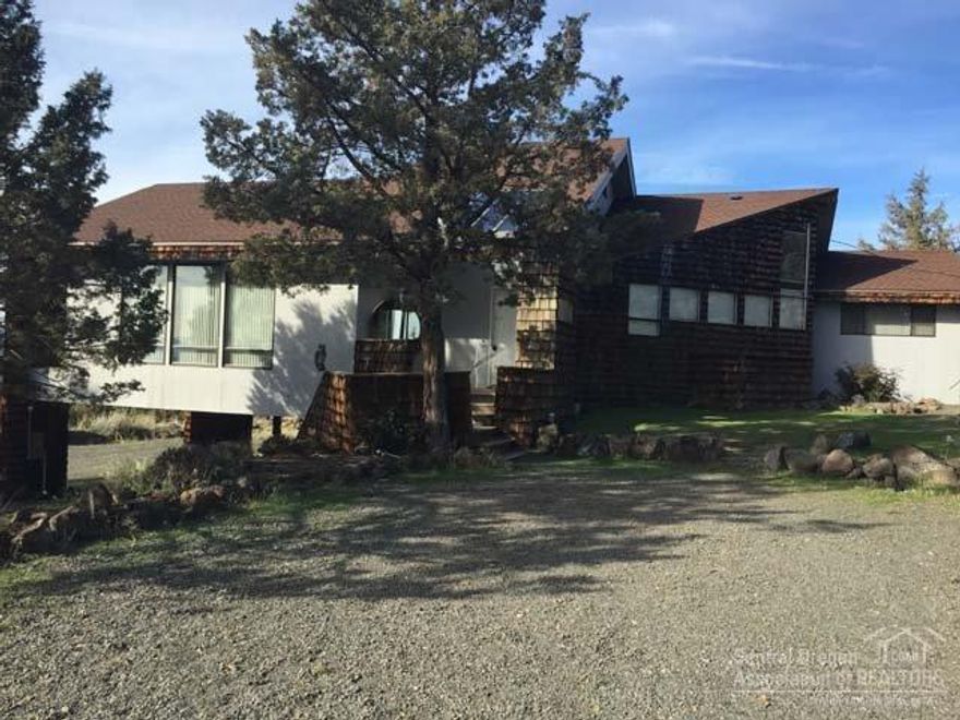 Breathtaking panoramic mountain, valley and peekaboo lake views from ever room in this 1888 SF architecturally designed Chalet style home. Huge deck w/sunken 17X32 pool. Home has cathedral ceilings throughout, inside walls covered in 1X3 premium grade cedar. 3 bed 2 bath w/extra loft. Drive through carport for easy turn around. Trap shooting and ATV riding out your back door or enjoy recreation of Lake Billy Chinook approx 7 miles west.