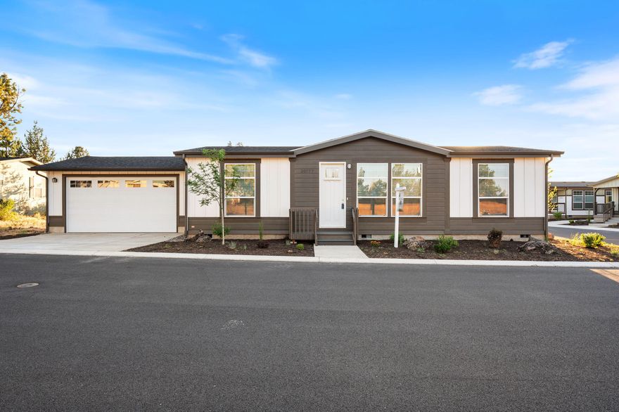 This stunning dream home features a striking 9&#8242; ceiling and an attached two car garage. The open floor design showcases a beautiful kitchen equipped with a stainless steel appliances and a charming farmhouse sink. White cabinets, with soft-close drawer guides and hinges, provide both style and practicality. The spacious living area features barn wood white vinyl flooring, while the kitchen island serves as the perfect gathering spot for family and friends. Experience luxury in this energy efficient home featuring an Energy Star rating, complete with central A/C. The elegance continues with quartz countertops throughout the home. The living room is accentuated by a tray ceiling, enhancing the overall ambiance. Additional features include a paddle fan in the living room and stylish pendant lights over the kitchen island, making this home perfect for both relaxation and entertaining. This residence is not just a house; it's a lifestyle defined by style, comfort, and efficiency.