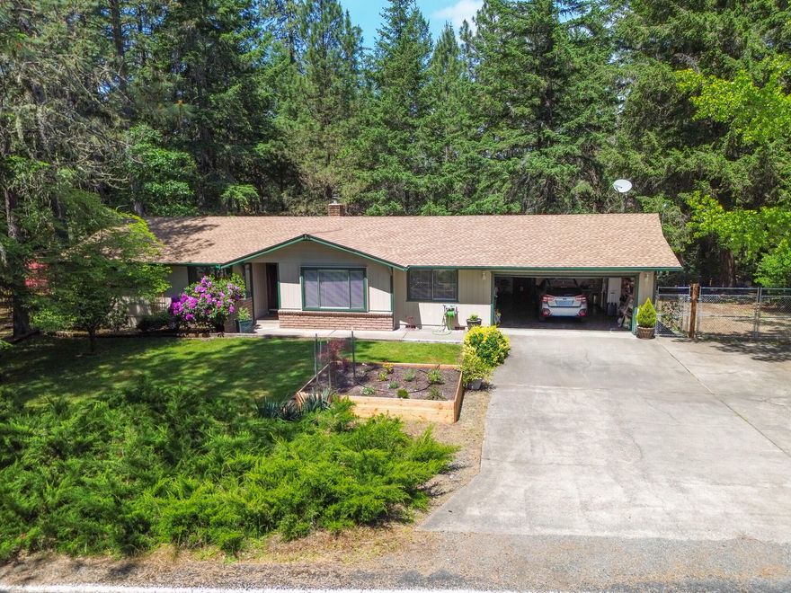 Don't let the age fool you—this well-maintained home is full of thoughtful upgrades! A new roof was installed just a year ago, and the newer heat pump ensures year-round comfort. Step inside to find a spacious, open-concept living room, formal dining area, and a cozy breakfast nook—perfect for both entertaining and everyday living.
The laundry area includes extra space, ideal for a pantry or additional storage. There's even a small room in the garage that could serve as a workshop, hobby space, or simply more storage.
The home features generously sized bedrooms, a beautiful deck for outdoor gatherings, and a fully fenced, landscaped yard. RV parking is conveniently located to the side of the home, and the tranquil forest backdrop offers a rare sense of privacy and nature.  Come see all this home has to offer—you won't want to miss it!