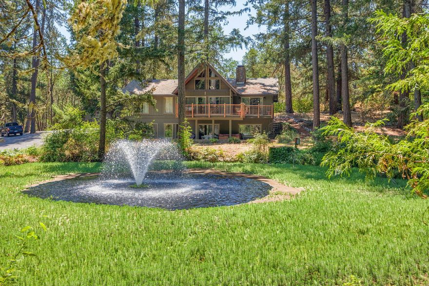 Need a shop? Don't miss this shop with 2,550 sf and a 1/2 bath, washer/dryer hook up and hot water heater. Beautiful setting with water feature on 5.62 acres.  Featuring a 3 bedroom,2 bath home with 2958 sf includes finished basement; could be another bedroom/family room.  The cook will love the kitchen with Thermador Range/Oven and Hood, Knotty Pine cabinets, snack bar, laminate floors granite counters and an abundance of cabinets.  Great room with soaring wood ceiling, double sided fireplace and large picture windows to take in the views.  En-suite bedroom with walk-in closet, laminate floors and built-ins.  Detached 720 sf garage with loft storage and attached carport.  Put this amazing home on your list to show.