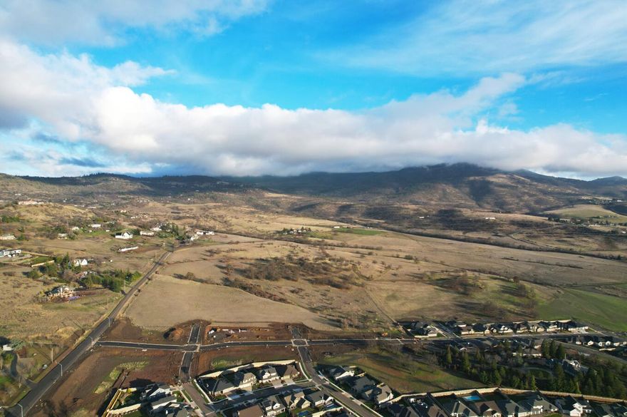 Great development / investment property with views. Located in a desirable area of Medford  right next to newer upscale subdivisions and just down the street from the Rogue Valley Country Club. According to the city it is split between lower density development (up to 6 homes per acre), and higher density (up to 10 homes per acre). These mixed subdivisions have been very successful in the area and allow for  larger upscale homes and smaller more affordable homes to be built. The adjacent subdivision has already brought the sewer close by and according to the city it should be easy and low cost for this development to connect. The county tax assessor has the real market value at over $6 million. This is a great deal on some of the best development land in Medford. Develop it now or just put it in your portfolio and watch the value grow as the surrounding land is developed!
