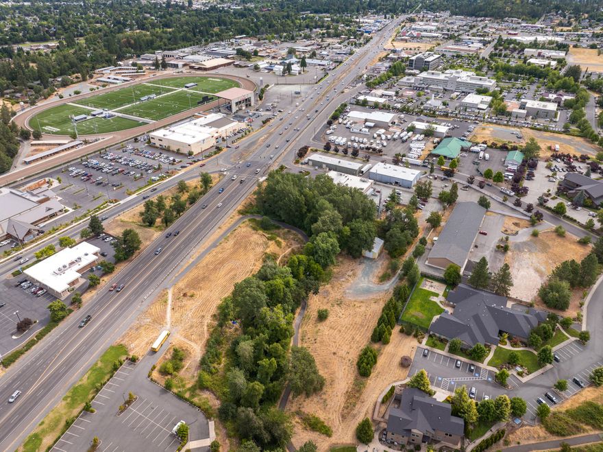 An exceptional commercial development opportunity in one of Grants Pass' most strategically positioned growth corridors! Located in the heart of the Redwood area and just minutes from Asante Three Rivers Medical Center, this 2.02-acre parcel offers prime visibility and connectivity—ideal for medical, professional, or service-oriented commercial ventures.
The property enjoys just over 600 feet of frontage on scenic Allen Creek and direct access to the Allen Creek Trail, providing possible foot traffic and  integration with the surrounding community. Zoned General Commercial (GC), the site supports a wide range of commercial uses—including retail, office, multifamily mixed-use, and more—with generous development allowances.
A 1,440 SF shop building on site offers immediate utility—perfect for contractors, trades, storage, or interim workspace while development plans are underway.