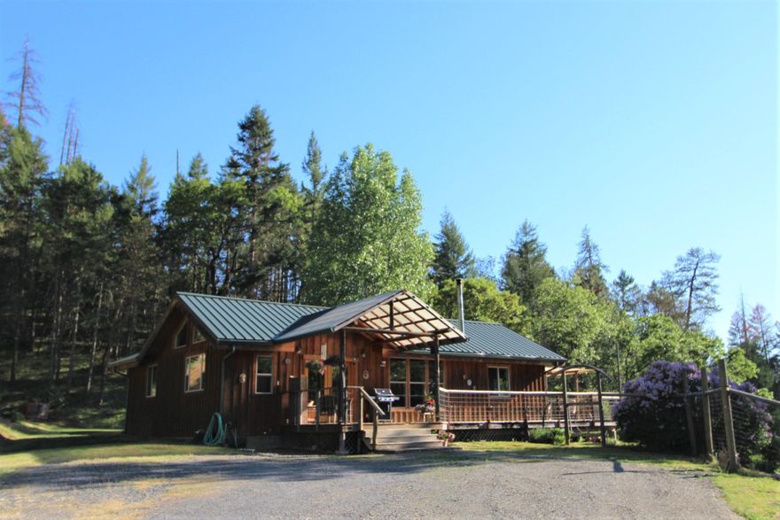 Back on market no fault of property. Total Privacy! One of a kind, Applegate Valley hidden mountain retreat. Listen to the birds sing & watch the wildlife roam in the comfort of this remodeled 1965 ranch style home, sits on over 91 ac. w/ 3 tax lots. Land features a ridge top cabin, 24 X 36 shop, greenhouse, organic gardens, seasonal spring fed ponds & streams. Situated in it's own private valley below Woodrat Mountain in Ruch w/ access from both sides, Upper Applegate Rd. & Sterling Creek Rd.. The 3bd, 2bth, solar powered home was remodeled w/ sustainably harvested wood. Custom milled cedar siding, fir flooring, blue pine interior walls, yew and walnut wood natural edge window sills & trim. Open floor plan includes, kitchen w/ granite counters & custom hickory cabinets w/ propane appliances. Enjoy the outdoors w/ the wrap around deck & back patio. Trails & quad access throughout the property. Backed two sides by BLM. Seller is a licensed realtor in the state of OR.