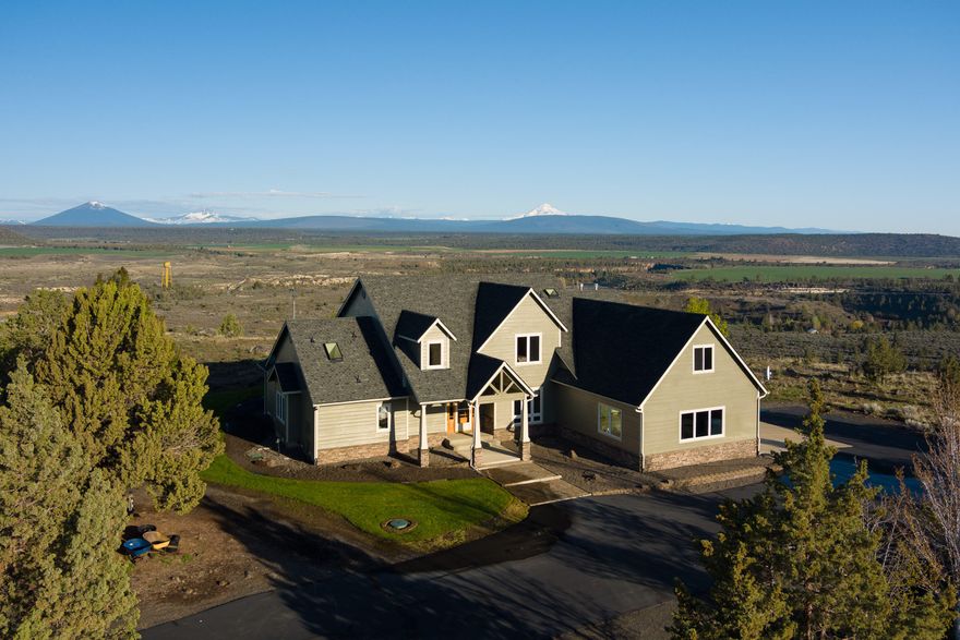 Panoramic Cascade Mountain & Deschutes River views bring the majesty of the Central Oregon outdoors inside this custom main floor primary home on 9.9 acres w/direct access to public land & the river for recreation. The great room has two living areas, dining area, & gourmet kitchen w/granite, Sub Zero fridge/freezer, dual Fisher Paykel dishwashers, & propane down draft cooktop. The primary suite has access to the deck, jetted tub, dual vanity, large double headed tiled shower, amazing walk-in closet & views second to none. Upstairs there's a spacious bonus room overlooking the river, two guest bedrooms, generous double vanity guest bathroom, & 800sf heated/cooled bonus room w/out flooring & not counted in the square footage. Outside there is a covered patio w/unbeatable views. The detached 676sf shop is heated/insulated & includes a full suite of tools & woodworking equipment. All the furnishings & tools pictured are included. Click the virtual media link for an extensive video tour.