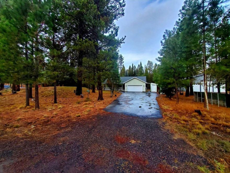 This 3 bedroom 2 bath home on a 1/2 acre lot is located near the Deschutes River. Sunriver's Resort, shops, restaurants, and services are just down the road with easy access to Bend, Redmond, and Central Oregon's beautiful landscape. Large front porch and full-length deck in back. Home is on its own well and septic system. The wood stove provides ample heat for those winter nights. Great room has vaulted ceilings with skylights and large windows for plenty of natural light. The water softener and well pressure tank are conveniently located in the two-car garage. Extra storage is just to the side of the home in a detached shed. Step out of your master bedroom onto the large deck and enjoy a secluded feeling with pine trees all around. The property lines are marked with green t-posts for the easier addition of a privacy fence. This well-built home is ready for your finishing touches and upgrades. Property being offered ''AS-IS
