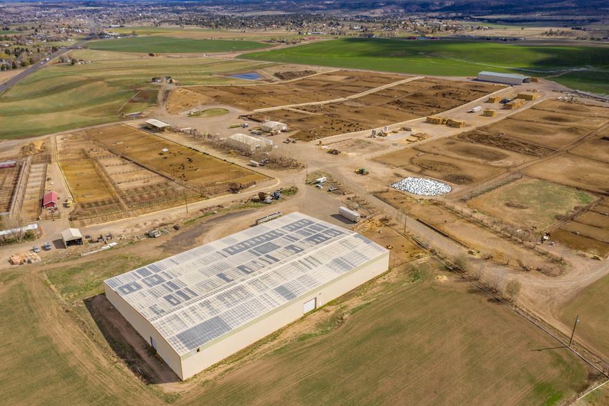 Green's Feedlot is a 6000 head, CAFO approved feedlot, neighboring the only livestock auction in the area. This efficiently planned facility is set up with cattle health and operator ease in mind.  Within the last year there has been additional capital improvements including concrete bunks and indoor commodities storage. There are 75.4 acres of north unit irrigation that has used for hay/grazing forage production. The 2,699 sq. ft. triple wide manufactured home shows exceptional pride of ownership.  With custom upgrades, the home is far beyond a typical manufactured home.  This amazing property also boasts; a 2,680 sq. ft processing building (including hydraulic chute and built in tub and sweep).   A 4,800 sq. ft machine shop.   309 x 189 (58,401 sq. ft) indoor arena, 47 feed pens with custom pipe fencing and 8 ft aprons.   A 20,000 lb. livestock scale.  A trailer washout station (supplemental income).  As well as an outdoor team roping arena with a calf lane.