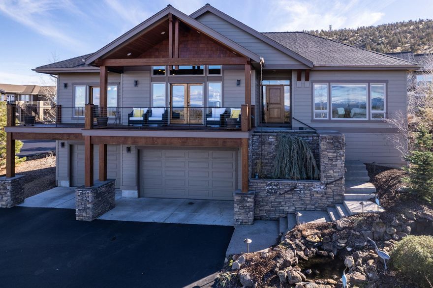 This FURNISHED custom home offers stunning views of the Cascade and Ochoco Mountains, Black Butte, and Smith Rock. Step inside and be captivated by the open floor plan, vaulted ceilings, stacked stone fireplace, solid hickory floors, and knotty alder cabinetry throughout.

The spacious kitchen is a chef's dream, featuring endless slab granite countertops, custom cabinetry with specialty storage drawers, and high-end appliances.

Enjoy your morning coffee on the front deck, taking in the breathtaking views, or relax on the private deck in the back, complete with a fan and a heater for year-round enjoyment.

The primary suite is a sanctuary, with a walk-in steam shower, and dual-sink vanity with solid quartz countertops.

With a full bath and two guest rooms, including one with a built-in Murphy bed and workstation, there's plenty of room for guests.
Extended triple-car garage with room for a workshop. Plus, the large driveway and parking pad make hosting guests a breeze.