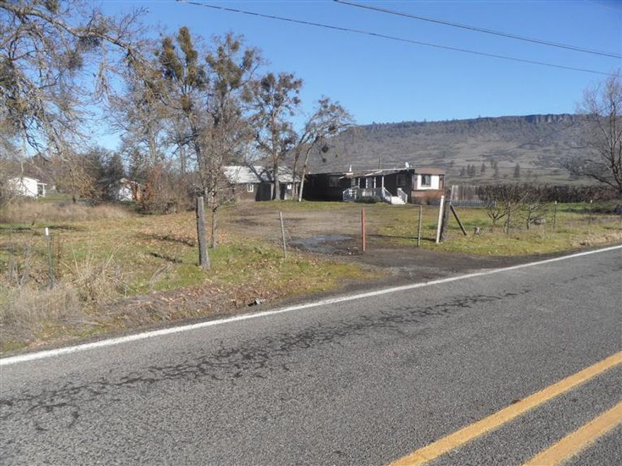 Great Lot with shop/out Building, Has old mobile home (little or No Value). Has well and septic. Pull old mobile off and build new home or replace with new mobile or manufactured home. 1.13 Acres are level and wooded and have panaromic views of the mountain ranges with Table Rock Mountains on each side and snow capped Mt Pitt showing in the front. Lots of room for RV, parking, toys and even installing a swimming pool. Mature trees need some work, seasonal creek and good public paved roads Property was acquired through Foreclosure, Seller makes not representations or warranties. Property Sold AS-IS. Buyer to do all due diligence and inspections. Seller may subordinate if paid in full from first draw of construction loan. Seller may carry, submit offers.
