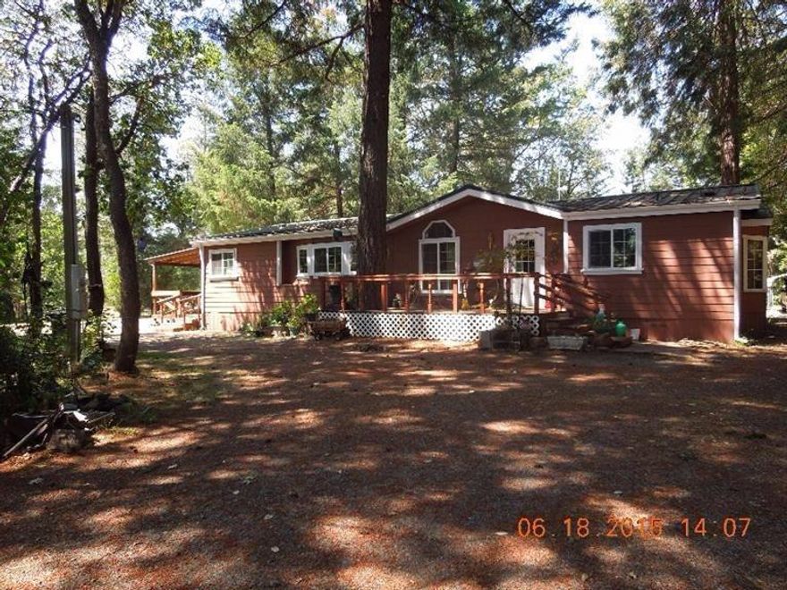 Nice 3 bedroom 2 bath home. Currently using one bedroom as a den. Nicely wooded around the home with some cleared area for gardening or animals. Outbuildings include a shed and garage with concrete floor, electricity and 220V. Nice decks in front and back. Two tax lots included! 1.15 and 1.19. The home has hardi-board exterior, a metal roof and was upgraded approx. 5 years ago with all new double pane windows. There is a garden tub and separate shower in the master bath. Nice built in hutches in the living room and a small island in the kitchen. Mature landscaping and large trees around the home for shade. There is a wood stove, an oil heater, and a forced air electric furnace. Come see this well taken care of home.