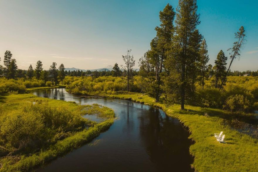A rare Central Oregon riverfront gem! This 5,200+ SF lodge-style retreat on 2.7 private acres offers pristine Little Deschutes River frontage with a private dock, gazebo, walking path, and float access to La Pine State Park. Designed for comfort and connection, it features 5 bedrooms, 4.5 baths, two kitchens, multiple living areas, and space to host up to 14 guests. Enjoy a heated indoor pool, hot tub, home theater, and stunning mountain views from the newly renovated deck. Whether you're seeking a high-performing vacation rental, multi-generational retreat, or lifestyle investment, this fully furnished, turnkey property delivers luxury, flexibility, and income potential—homes like this are few and far between.