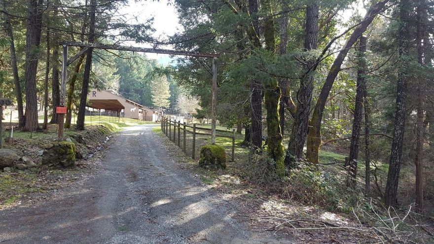 Seclusion on 77 acres with usually year round Savage Creek, this former miniature donkey ranch is a possible legal 3 family setup. The comfortable older home has engineered laminate flooring, fireplace, and includes 3 bedrooms, 2 baths, an office, and a pantry off the laundry room. The heat pump is just 2 years old. Connected to the detached garage is a 4th bedroom with bath plus a store room and art room. There is a 43x58 covered arena with 10'4x 20'8 insulated tack room and several fenced pastures with shelters. The barn has 5 stalls for minis, some hay storage and potting shed. Other outbuildings include a large double carport and a large hay shelter, plus two large shops and a 1440 square foot 1979 hardship manufactured home.