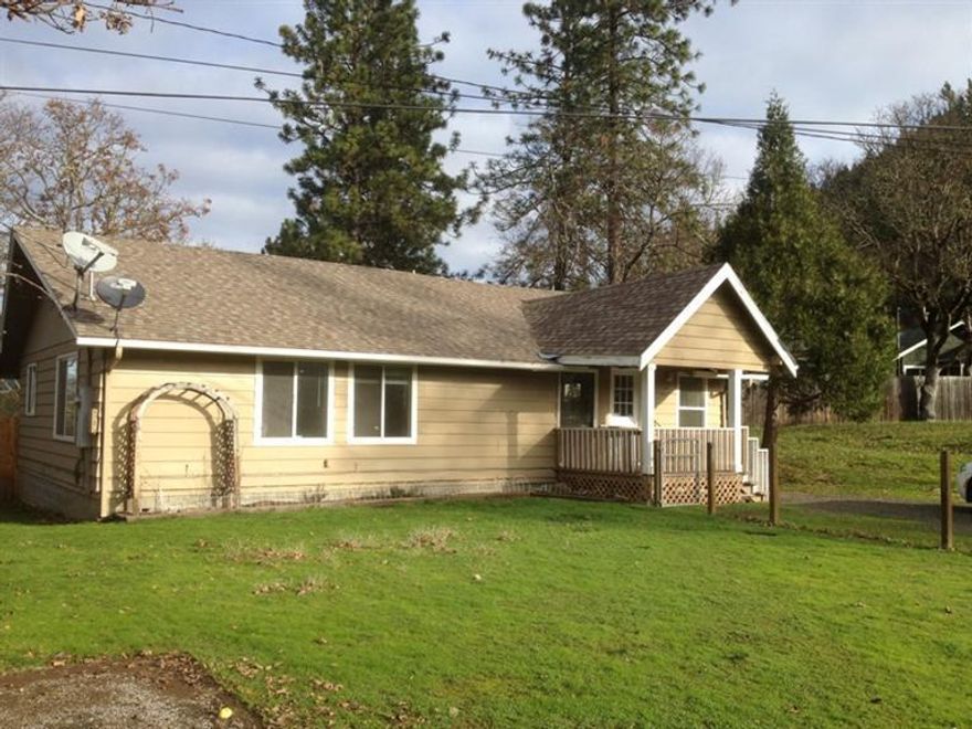 Well built 4 bedroom home in nice area in Shady Cove on .28 acre lot. Large living room, nice size bedrooms and baths. Great kitchen with windows bringing in the outdoors. Good floor plan, heat pump, large indoor utility room and slider onto the rear deck. Both the front & backyard are fenced, plus there's room to build a garage. Property offers pretty trees & territorial views, located in a nice neighborhood with upscale homes.