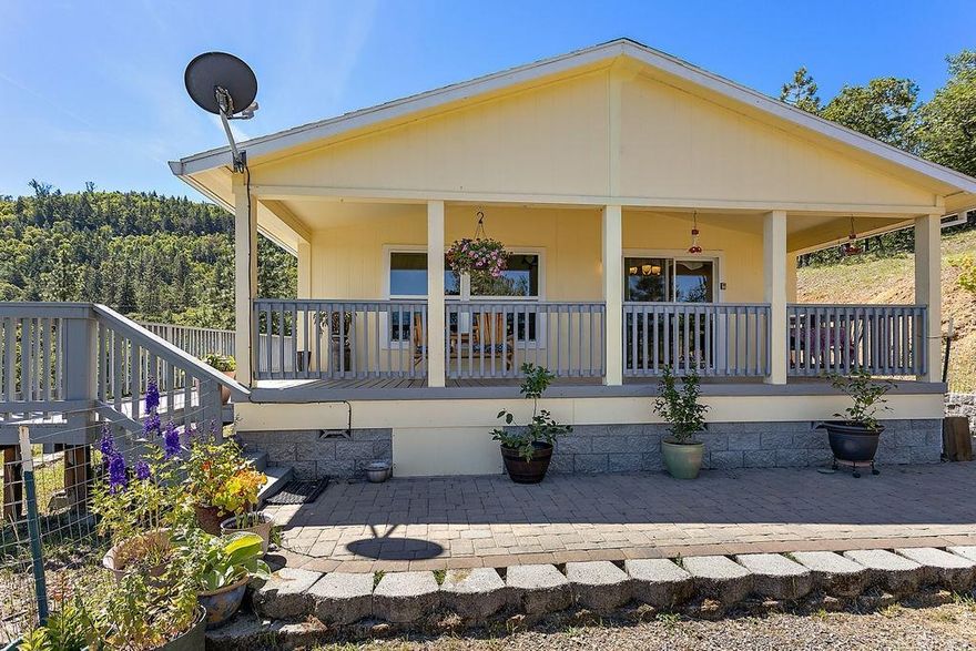 Breathtaking views from this 5 acre beautiful home in the hills of Eagle Point. This 2010 manufactured home has hardy plank siding & a covered porch to enjoy the views. This home features an open concept. Easily, you can turn the office/den into a 3rd bedroom. Freshly painted inside, new dishwasher, garbage disposal, Arlo alarm system, freshly painted deck, new 8x12 shed & so much more. This home is certified energy efficient. Monitor tankless water heater. Motorized exterior sun screens. Both front & back storm doors are convertible to screen doors. Cabinets in the kitchen are knotty alder w/pull out drawers. Dbl sinks in the master bathroom & a walk-in closet. There is a 2000 gallon concrete water holding tank in the ground to give you plenty of water from the well. Separate room for the pressure tank & water softener. The 24'x24' dbl car garage has storage cabinetry & work bench. The dbl door entry has a pull down screen to work in the garage. Incl. newer washer/dryer & fridge.