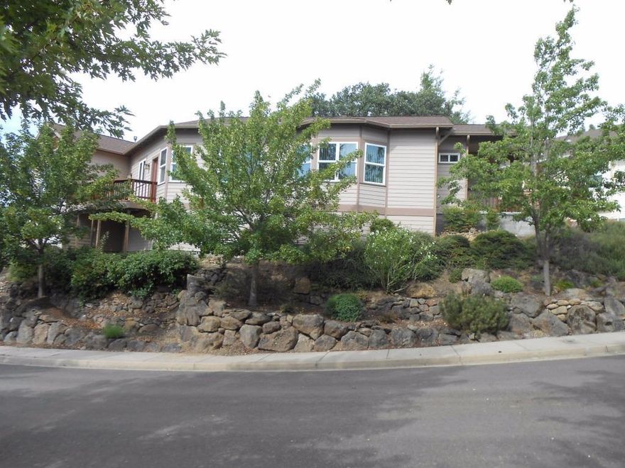 Gorgeous single family home sitting high on a hill with spectacular mountain views!!! Home is located in the sought after Great Oaks neighborhood of Mountain Meadows 55+ Community. Expansive views from the numerous windows and front deck of this spacious home. Walk into the tiled entry way and you will find a lovely office/den to your right. Straight ahead is the gorgeous Living/Dining area with beautiful hardwood floors, vaulted ceilings, a wall of windows, and a gas fireplace surrounded in shelves. Glass doors off the dining area lead to a large rear deck, great for entertaining. Beautiful, well appointed kitchen with breakfast area where you can walk out on the deck and enjoy the views & your morning coffee! Large Master Suite with walk-in closet, nice bath, and more windows to enjoy the views! Home has central vacuum system, 2 car garage, and a very small partial basement that would be great for extra storage. This is a one of kind home with a great location!!