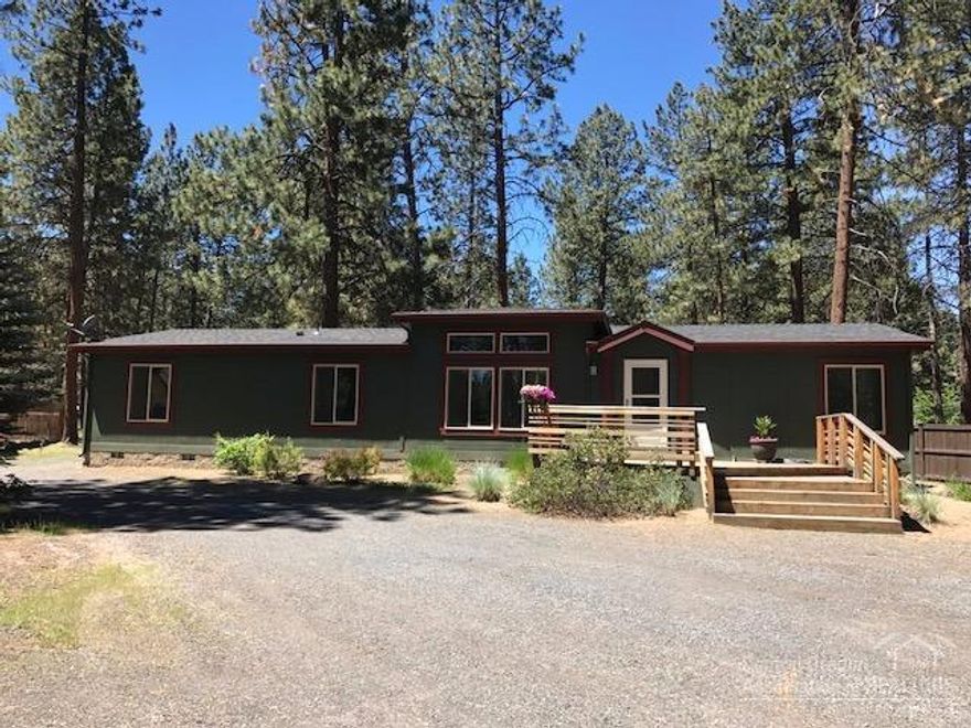 Not a typical manufactured home. Upgraded, new windows & roof, new stainless steel appliances, updated fixtures, large pantry, laminate flooring, new carpet in bedrooms. Light and bright open great room, vaults, skylights, large master, with huge soaking tub and shower. 2nd bath has an all new tile shower. Huge decks front & back plus an approximately 20x20 detached garage on the large lot. Partial fenced with lots of parking for toys!