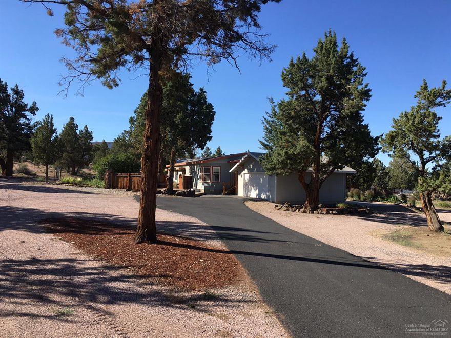 Landscaped 3 Acres with mature Juniper trees and an Easterly view of the Powell Buttes. Includes a 1996 Manufactured Home with two decks, a detached double garage and an RV storage barn. Nicely landscaped yard with a fenced vegetable garden. Set up your private showing today!
