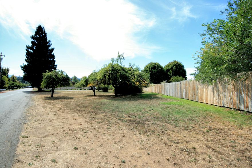 Located on the edge of town on a quiet and hidden cul-de-sac. This is a quaint .23 acre lot with a few mature fruit trees and even irrigation rights to keep your yard lush. Public sewer available. Well needed. Easy access and location to many convenient stores without needing to go downtown. Very quite and private neighborhood. This lot is shaped and located for a quaint and comfortable home of your choosing.