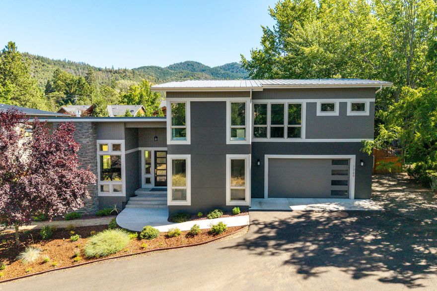 Nestled on a private lane shared with just two other homes, this inviting contemporary residence offers a perfect blend of style, comfort, and privacy. Designed and built in 2017, the home features an open, light-filled floor plan with lovely hardwood flooring. The gourmet kitchen is a chef's dream, complete with granite countertops, an expansive eating bar, and custom-painted cabinetry. The great room is a showstopper with soaring ceilings, a charming fireplace, and expansive windows that bring stunning mountain views and natural light indoors. The main level is home to a peaceful primary suite, a versatile second bedroom/office, 2nd full bath, a convenient laundry room, and a 2-car-attached garage. Upstairs, you'll find two additional bedrooms, a 3rd full bath, and a spacious bonus room that can be tailored to your needs. Set on a .39-acre landscaped lot with w/ raised garden beds, a fully fenced backyard, deck, and TID irrigation rights—this home is an absolute must-see!