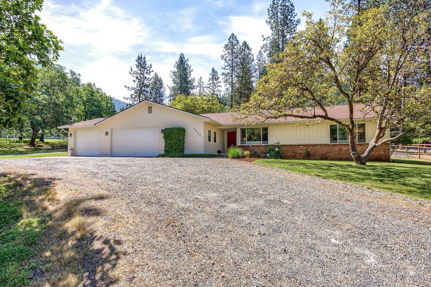 Beautifully updated home with a country feel minutes to Grants Pass.  This home is turn key/move in ready.  Kitchen has been redone to include large island with pendant lighting, slow close cabinets, breakfast bar and stainless appliances(included in sale), numerous windows for natural light and tons of cabinet space.  Livingroom has a propane fireplace.  Primary suite has walk-in closet, tiled tub/shower combo, dual vanity and porcelain tile floors.  Front bath has a large tiled shower with glass doors.  2 more nicely sized bedrooms.  Large laundry room with attached  half bath.  Covered patio.  Fresh exterior paint.  Shop/RV barn with room for all your toys and RV hookups.