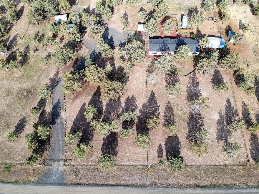 Small acreage and spacious home with an abundance of possibilities! Two taxlots offer 3.64 combined acres with a great set up for animals. This property is fully fenced, has covered loafing shed, chicken coop, machine shop, and gardening shed offering multiple uses. Private back yard with paver patio, sprinkler system and low maintenance charming landscape. Easy access to BLM land in a clean, nice subdivision. Must see to appreciate the area and care this property has received. Great value here!