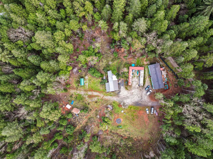 Two homes on over SEVEN Acres.
Fantastic opportunity in the very sought after Marcy Loop area. Minutes from town, yet in the country. The Main home has Three bedrooms, two baths, open floor plan with newer floors and heat pump. Large living room and dining room with adjacent kitchen and large pantry. Second home is a Two-bedroom, one bath older manufactured home that was remodeled and is nice, cozy and comfortable. Both have decks and plenty of space for gardening. Alot of cleared land suitable for building your amazing dream home- or expanding current homes. Tremendous value. Four Connex boxes- one used for a hobby room currently and the others for storage. These will be staying with the property. Property is sold as is. Easy to show anytime with a 24 hour notice please. So MANY Possibilities here, come see for yourself in person with your favorite Broker.