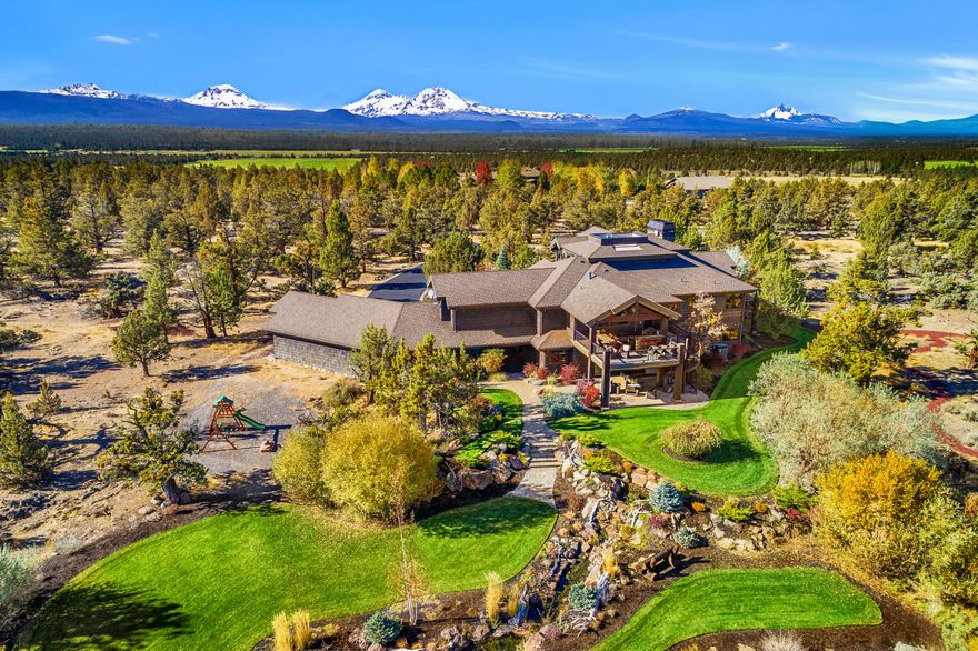 A truly special, one-of-a-kind, Northwest style home. Thoughtfully situated atop a hill capturing covetous 360 views, while showcasing the cascade mountains. Private & gated driveway serves 2 homes, making this unique Tumalo setting extremely hard to replicate. 
Elegance flows through the home, with water features inside and outside the main entry, hand crafted custom ironwork, hand distressed wood doors/trim, and immaculately manicured grounds with a cascading water feature in the backyard. Complete with a gourmet kitchen, theater room, sauna, laundry on both levels, wine cellar, elevator, office w/ its own entrance, loft, wet bar, bonus living areas, outdoor kitchen/patio with spiral staircase to yard,  and 4 car garage. This home was built with rock harvested from the property, hand-split cedar siding, reclaimed wood flooring, boastful beams & wood ceilings in living and formal dining, plus built-in speakers, floor-to-ceiling rock fireplace, and beautiful copper accents throughout.