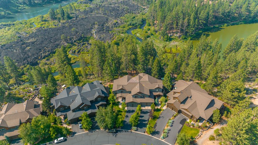 Luxury Riverfront townhome at Points West features 4 bdrm suites and 4.5 bths encompassing 3647 sqft located above the Deschutes River. Location is an outdoor enthusiasts paradise with Mt Bachelor and Cascade Lakes mins away. Nearby mtn biking trails & a paved bike trail to ride safely to town. Downstairs is an open floor plan with a stone fireplace, glass french doors to office, kitchen features tumbled edge granite counters, soft close cabinetry & a granite island. Primary bedroom/bath are located on the main floor with access to back patio to listen to the sound of the river or enjoy the outdoor gas fireplace. The large 2 car garage has easy maintenance epoxy floors. Upstairs features a guest family room with 3 bedroom suites. Sellers invested $14,000 in roof tape system that can be remotely controlled to prepare for winter snowfall. Many more features are attached. HOA covers water, garbage, landscaping, snow removal of roads, and exterior insurance and maintenance of structure.