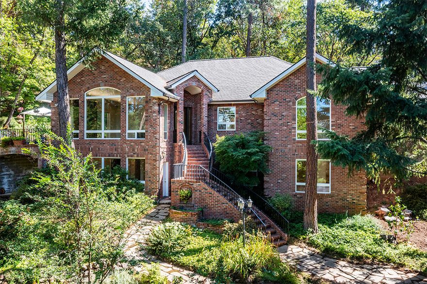 Tucked behind an elegant, gated entryway this exquisite private estate is surrounded by the charm of historic Jacksonville! Positioned on 2 acres, this 4 bed, 2.5 bath includes an oversized 2-car garage, plus a separate heated garage w/space for up to 4 vehicles, ample RV & boat parking. Designed for both everyday living & entertaining, the home features multiple living & dining areas on both levels. Elegant details & updates throughout including new hardwood floors, fresh interior paint, floor to ceiling windows, updated lighting, base, trim & moldings. Gourmet kitchen w/an oversized island, breakfast bar, granite countertops, adjacent nook & sunroom. Primary suite w/a decorator ceiling, 3 walk-in closets & a luxurious ensuite equipped w/a spa-quality shower, dual sink vanity & freestanding tub. Huge shop or hobby room ideal for projects. Amazing landscaping w/tile decks, paver walk-ways & gorgeous, wooded areas. Owner will carry at 4.99% with a 3-5 year call for qualified buyers!