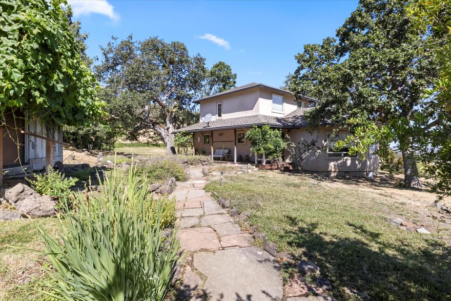 Ready to swap ordinary for extraordinary? Enjoy peaceful country vibes with this beautiful two-story home on 1.73 acres in Talent. Custom built in 1995 and lovingly cared for by the original owner, it offers panoramic views of vineyards, pastures, and rolling hills. Inside, you'll find 1,341 sq ft of space, a cozy living room with big picture windows, and a freshly remodeled kitchen that checks all the boxes - engineered stone counters, custom cabinetry, and solid appliances. There's one roomy bedroom upstairs, full baths on both levels, plus a mix of oak and carpeted floors. Outside, there's a handy garden shed, a carport, and plenty of room to relax or garden. Private and peaceful, but still close to town - this one's a gem.