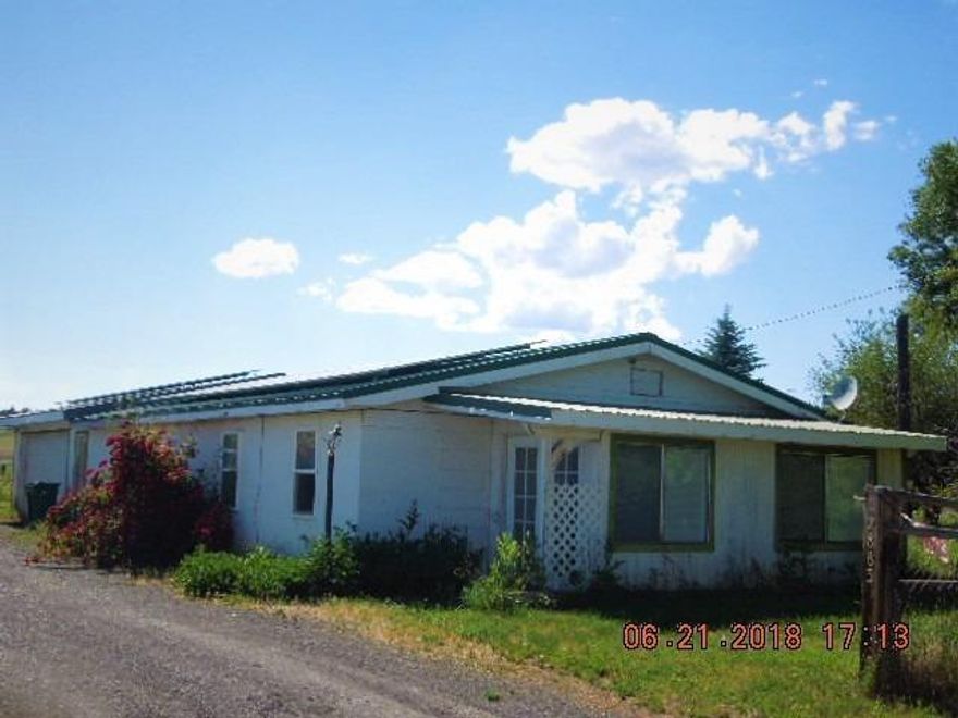 12883 Hwy 66: Looking for country living close to town? This 3 bedroom, 1 bathroom home on 2.61 acres could be just the property for you. Featuring some updates throughout, vinyl windows, tile, laminate, and carpet floors, 50 year metal roof, and 2 in 1 heat pump with AC. Kitchen is open to the dining and living room with large pantry/ storage room. Nice heated 2 car garage with laundry area and work bench. Through the garage is a fully fenced back yard with shed and pump house. Small animal shelter with pasture for your farm friends and flood irrigation available. Not to mention, the solar system on roof provides 100% of homes annual electricity usage. Call today, to make your showing appointment!