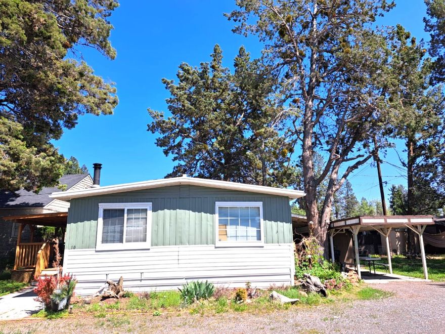 $11,000 Price Reduction! Seller Financing Available with this Motivated Seller!
Parrell Mobile Home Park rent is more affordable than other parks in Bend.This charming and affordable 2-bedroom, 1 bath Double-Wide home feels much larger than its 960&#8239;sq.&#8239;ft., thanks to an open layout, abundant natural light, and smart use of space that maximizes every square foot. The dining room features a beautiful built-in wood wall cabinets, complemented by large windows and warm wood accents throughout. A spacious front deck is perfect for entertaining.Enjoy a fenced backyard, covered detached carport, and two storage sheds, with parking for up to three vehicles (including one covered). Stay cozy year-round with a certified wood stove and a Castle pellet stove with programmable remote timer. The home includes all appliances, plus a like-new Samsung washer and dryer (only six months old).Located in a quiet neighborhood, close to shopping, restaurants, and everything Central Oregon has to offer.
