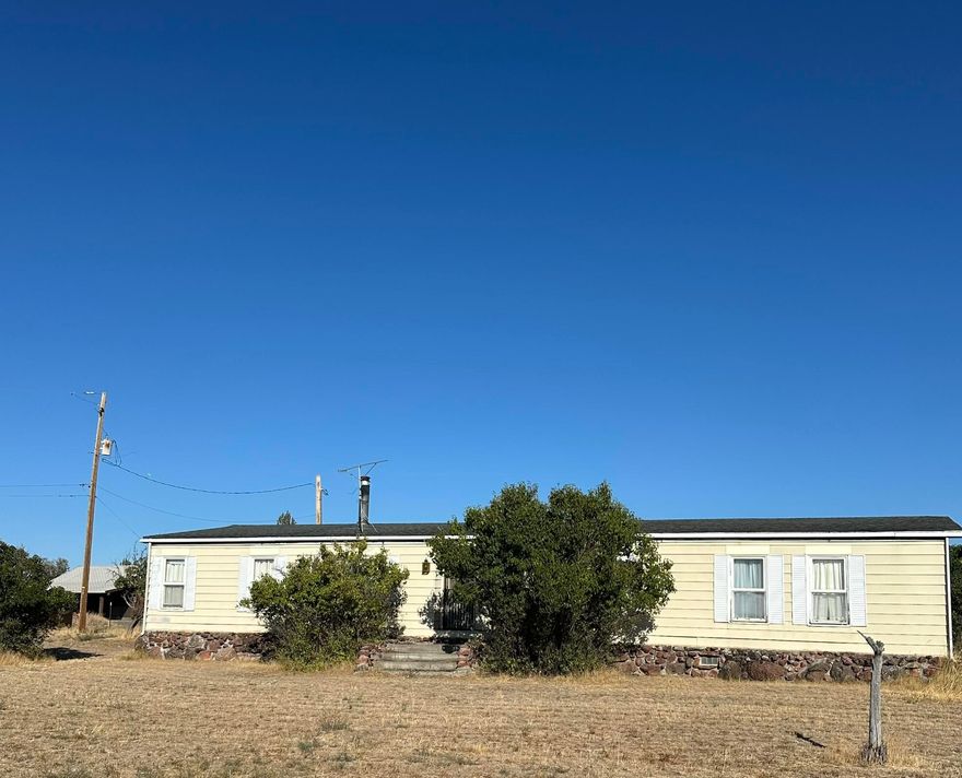 Bring your vision and make this 1848 sq ft, 4 bedroom, 2 bath home your own! Nestled on 20 peaceful acres with this property offers privacy and potential. The home features a spacious layout with two living areas, a wood stove, and vintage charm throughout. Outside you'll find multiple outbuildings including a large shop with covered parking and a storage shed—perfect for your hobbies, animals, or equipment. Plenty of room to expand, garden, or simply enjoy wide open space under big Central Oregon skies. Don't miss this opportunity to create your own rural retreat!