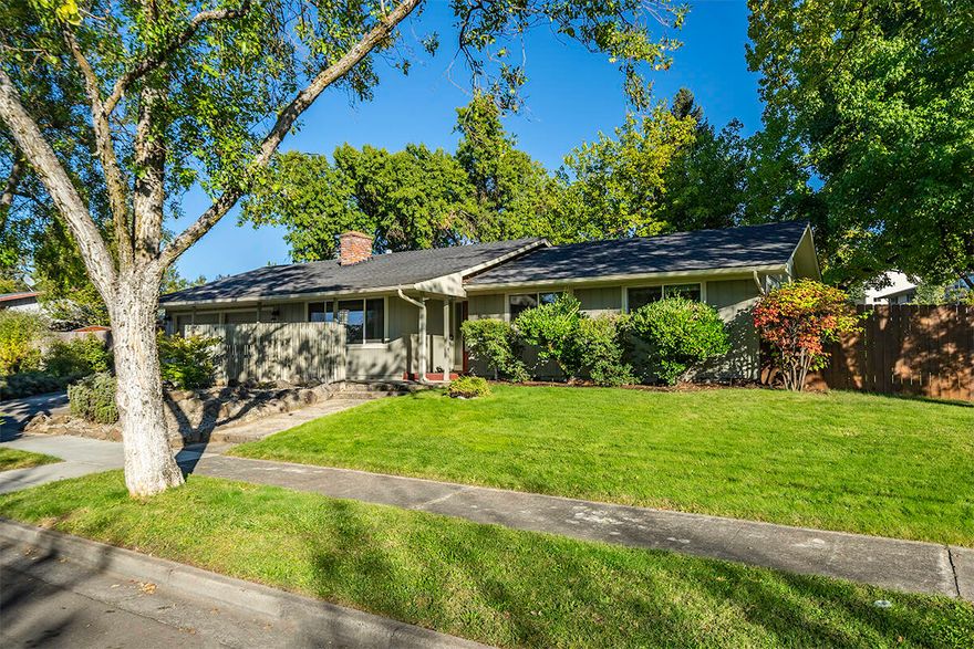 Looking for a big lot with a darling mid-century home?  Situated on a very spacious .29 acre, corner lot you will find this adorable 4 br 2 ba home ready for its new owners!  With 1432 sft all on one level the 1960s home has loads of charm including a brick surround, gas fireplace, gorgeous wood floors and lots of built-ins.  There is a covered patio out back for entertaining and the entire back yard is fenced and quite private.  In-ground sprinklers, lovely landscaping front and back really add to the curb appeal of this home.  Terrific location is close to shopping, public transportation, medical, schools and more.  There is a newer  roof, furnace, heat pump and updated electrical. vinyl windows and so much more.  2 car garage offers room for vehicles and plenty of storage too!