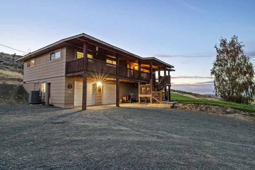 Discover your dream farm on 40+ acres, offering a perfect blend of irrigated ground, rolling pasture, and hillside terrain. With 18+ acres of prime irrigated soil and valuable water rights from a private well, this property is ideal for farming, livestock, or creating your own self-sustained haven. The spacious, updated home features 3 bedrooms and 2 bathrooms on the main floor, plus a fully finished basement that can serve as a second living quarters or an expansive primary suite with its own living room, bedroom, and bathroom. Step outside and take in the sweeping views from your porch, overlooking the arena that's perfect for riding or training. A functional barn, expansive garden space, and a private pond stocked with fish offer endless opportunities for work and play right at home. Ample parking and a pull-through driveway make it easy for trucks and trailers, rounding out this rare offering that combines practicality with beauty.