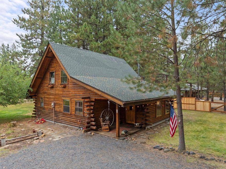 Welcome to your genuine log home, where rustic charm meets modern comfort. As you enter, the inviting river-rock hearth and the warmth of the wood stove greet you, creating a cozy atmosphere. Relax in your comfortable chair and admire the tongue and groove wood-beamed ceiling. Unwind on the expansive cedar deck as you enjoy the lush, irrigated lawn and mature Ponderosa Pines. This two-story residence spans 1,592 square feet and features three bedrooms and two bathrooms, offering ample space on its 0.54-acre lot. The generous property provides plenty of room to build a garage or shop and a has new in 2024 upgraded septic system.  Nestled in the highly desirable Tollgate community, this location is surrounded by public lands and conveniently positioned just 2 miles west of Sisters via Highway 20. Tollgate's amenities, including a paved bike and walking trail, swift access to public lands, a swimming pool, club house, tennis & pickleball basketball court, and a park. A must see home!