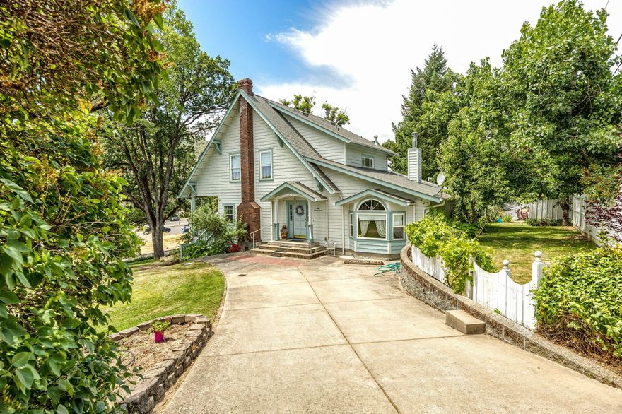 Tucked away in the heart of Gold Hill, this thoughtfully rebuilt home at 127 4th Avenue blends modern comfort with the character of a classic residence once owned by Gold Hill's first banker. Designed as a modern replica of the original home that stood on this very lot, today's version offers a warm, light-filled layout, efficient systems, and a timeless charm that's hard to find. The property spans multiple lots, creating opportunities for a future garage, expanded outdoor space, gardening, or additional parking. The unfinished basement adds flexibility and may offer potential for an ADU or creative (buyer(s) to do all due diligence). Outside, enjoy a private backyard, off-street parking, and walkable access to the Rogue River, parks, and the small-town charm that makes Gold Hill such a hidden gem. Whether you're looking for your first home, a quiet place to call your own river retreat, or are seeking a low-maintenance investment in a growing area, this one is worth a closer look.