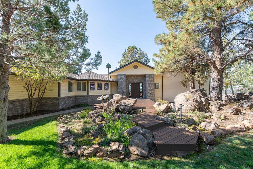 Just 20 minutes from Bend, this 3077 sqft home  on 2.52 acres offers breathtaking Cascade Range vistas. Built in 1992, the home features 3 bdrms, 3 baths + powder. Living, dining & kitchen areas are framed by large windows showcasing sweeping mountain views. Kitchen includes tile counters, double wall ovens, microwave, dishwasher, refrigerator & extended island - ideal for entertaining! All major appliances; refrigerator, washer, dryer included. Front & rear yard are fully fenced, with mature trees & sprinkler systems. Property includes 3-car garage, detached shop & RV bay. Expansive rear deck runs full width of home, delivering panoramic views & a tranquil outdoor living space. Combining country peace with accessibility- close to Bend, hospital & shopping - it's a rare opportunity!