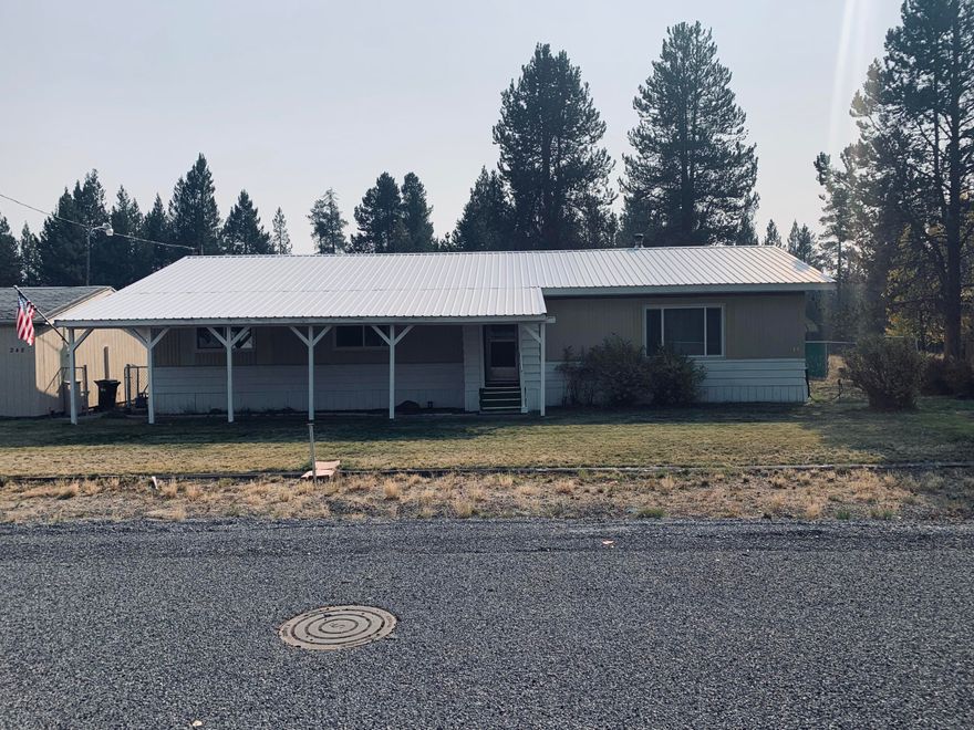 Beautiful edge of town 1 acre  property with lots of storage and space. Landscaping  and mature trees make it a great setting. Detached 2 car garage with garage opener, RV shelter, additional shop, and another space that resembles a garage yet it is a shop/storage.  Washer and dryer is located in front garage area. Additional sq ft not listed with county in sunroom with many windows and 1/2 bathroom.  2bedrooms and 2 bathrooms, living room, dining area and large kitchen.. Kitchen has updated cabinets, appliances and new flooring.  Some updating will make this an amazing space.  Call your favorite Real Estate Broker for a tour.