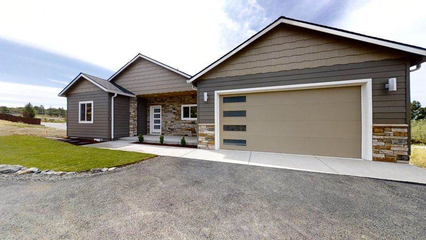 Another Beautiful contemporary new home with all the amenities you want! Just finished & Move In Ready! Lg vaulted ceilings, huge open kitchen w/ granite counters, Lg Island, stainless steel appliances including 5 burner gas cook top & convection oven & microwave. Amazing wood laminate floors in all main areas w/ carpet in bedrooms & tile floors in bathrooms & laundry room w/ deep sink. Lg master suite w/ French Door to covered deck, dbl sinks w/ granite counters, lg tile shower w/ tile pebble floor + water closet. Designer cabinets w/ soft close drawers. Split floor plan. Gas log fireplace in living rm w/ wet bar w/ cabinets & glass shelves. Dining rm w/ lg slider & Trapezoid window to a lg covered deck w/ beautiful mountain & sunset views to enjoy on the covered deck. All landscaping will be completed soon.