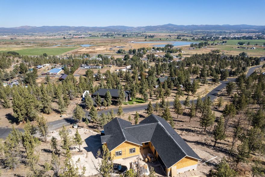 Enjoy the perfect blend of country living and modern comfort on 4 private acres, just minutes from Prineville. This single-level home is set in a peaceful rural setting with sweeping 180-degree views of the surrounding landscape - ideal for soaking in Central Oregon's sunrises and sunsets. Inside, the open layout shines with vaulted ceilings and a light-filled design that flows seamlessly from kitchen, with butler pantry, to dining to living areas, creating a warm and inviting atmosphere for both everyday living and entertaining. In addition to the attached garage, the property includes a heated driveway and an extra garage/workspace - perfect for projects, storage, or hobbies. With its privacy, space to spread out, and easy access to town, this property truly offers the best of both worlds.