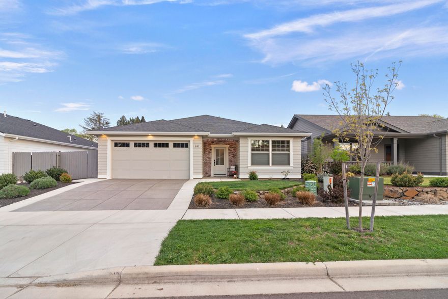 Gorgeous one level contemporary, craftsman style home in South Medford with attention to detail & designer features. Open floor plan with engineered hardwoods, box beam ceiling, gas fireplace & A/C! You'll love the kitchen with quartz counters, wall of cabinets & SS appliances, including a gas range. Coveted large pantry with barn door and the essential island complete with bar seating. Retreat to the spacious main bedroom boasting vaulted ceiling & en suite bathroom offering double sinks, large walk-in tiled shower & walk-in closet. Plenty of space including two additional bedrooms & full bath. Even the laundry room is lovely with designer tile & built-in cabinets. Double car garage with extra attic storage. Fully fenced landscaped yard adds privacy along with a covered patio, space for fire pit, grill, smoker, pizza oven. Detached workshop/shed offers even more storage or craft space. Little or no electric bill with owned SOLAR panels. Quick trip to Cartwright's, Golf Course & I-5.
