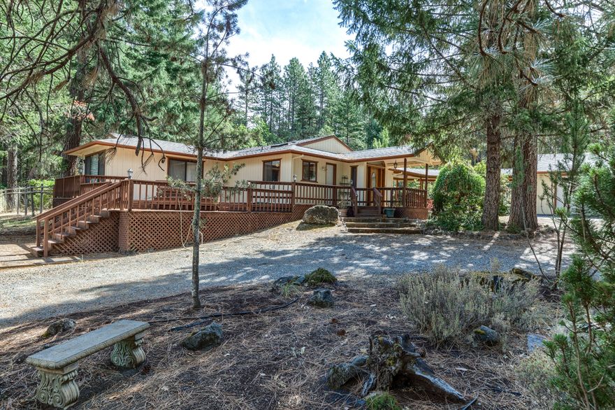 Get away from the city and start your new adventure in Southern Oregon today! Well kept custom built home on 40 acres just outside Grants Pass. Covered front porch welcomes you to, multiple living areas, efficient kitchen, three bedrooms, 2 bathrooms, dining area, large laundry room, vaulted ceilings and multiple skylights throughout. The woodstove will keep you warm in the winter and the sunroom off the primary bedroom is a perfectly peaceful retreat. Outside the home is a multi-tiered pond, detached garage with carport connected by a covered breezeway, an additional barn and separate workshop ensuring everyone has a place for their projects. There is a fenced garden area, numerous flowering trees, perfect for the outdoor enthusiast. This property gives the peaceful country feel with low county taxes while being close to city services.